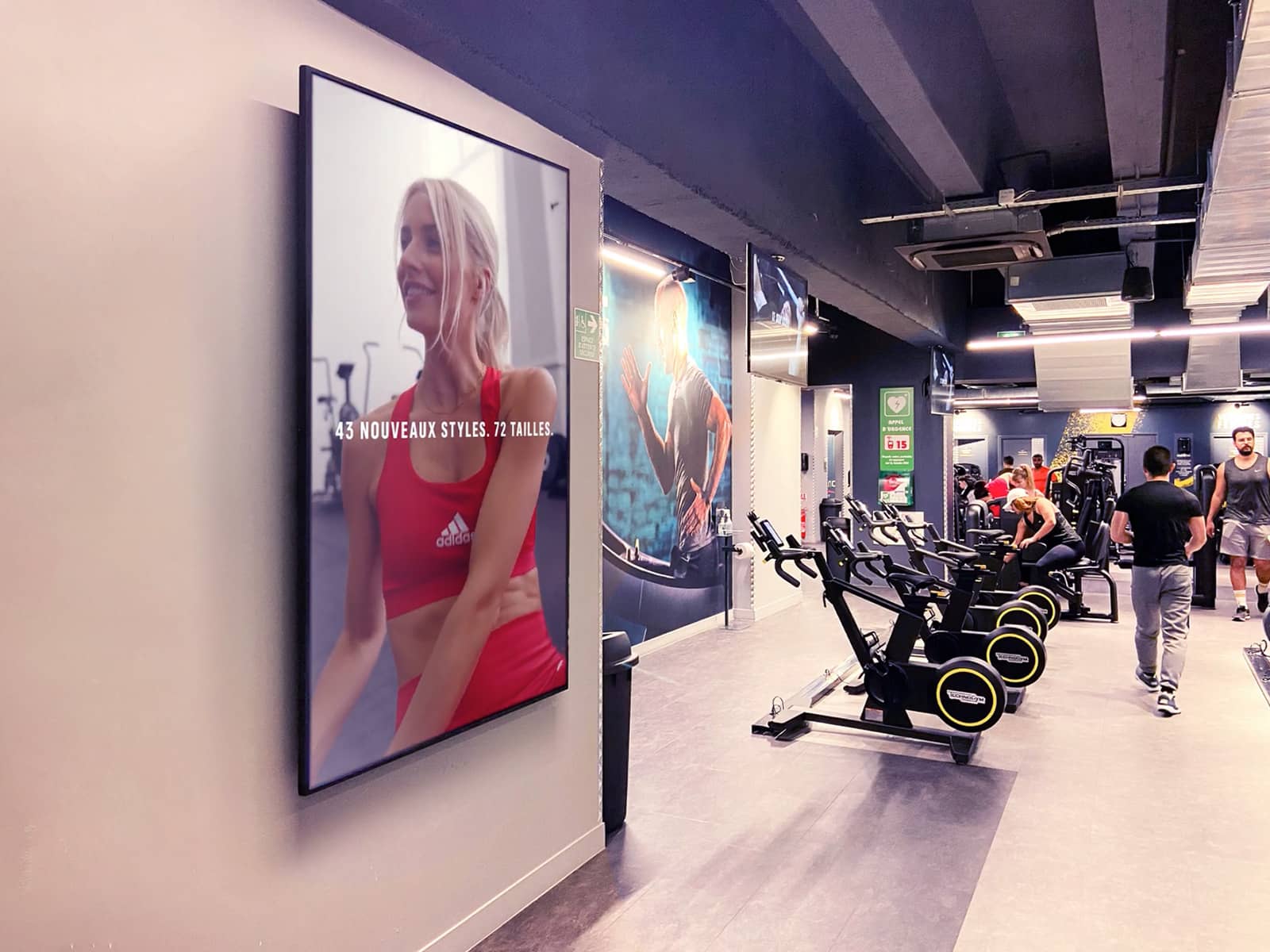 réseau DOOH proximité exemple en salle de fitness